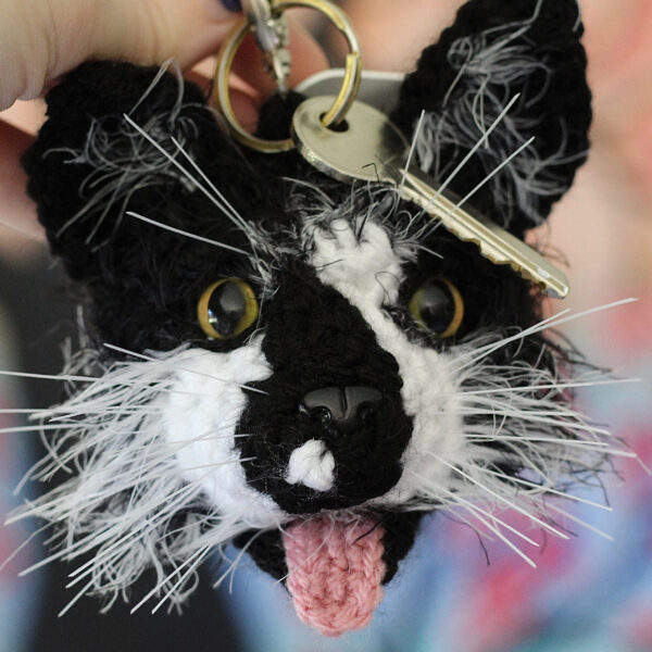 A personalised crochet soft toy head of your cat created from photographs of your furry companion, lovingly attached to a hanging silver lobster clasp.