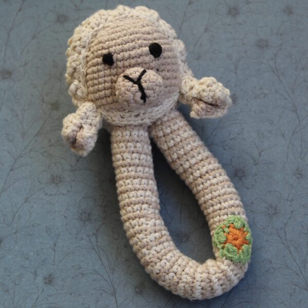 A beautifully handcrafted lamb baby rattle, the perfect gift for any little one.