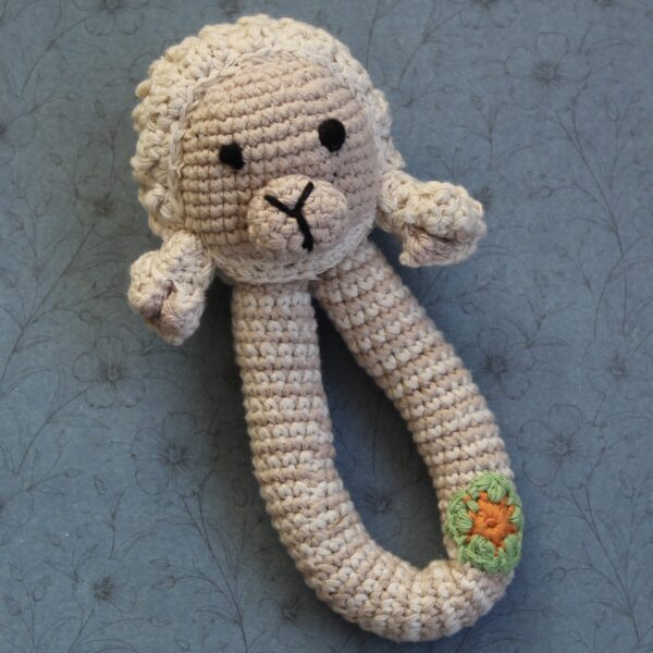 A beautifully handcrafted lamb baby rattle, the perfect gift for any little one.