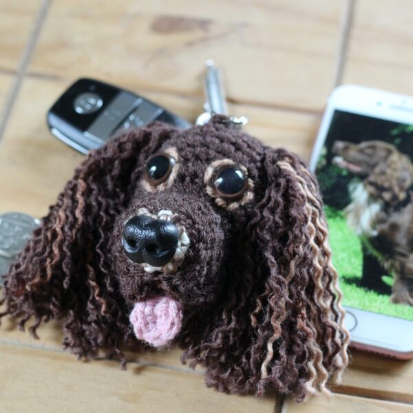 A personalised crochet soft toy head of your pooch created from photographs of your furry companion, lovingly attached to a hanging silver lobster clasp.