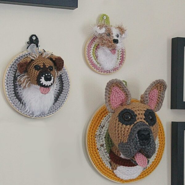 A bespoke and handcrafted crochet soft toy head created from photographs of your furry companion, lovingly mounted on a hanging embroidery hoop.